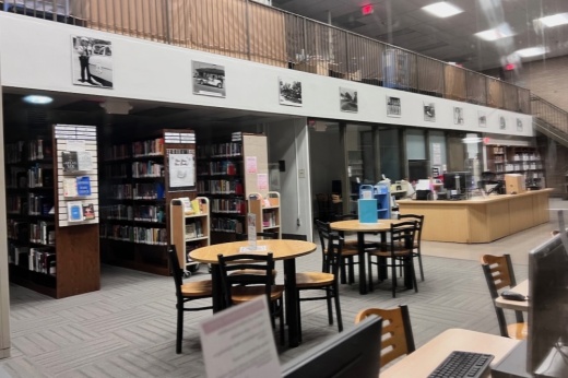 tables, chairs and bookshelves in a library