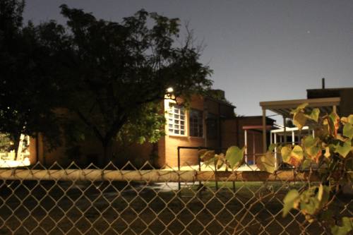 A photo of the Rosedale facility with a fence at night