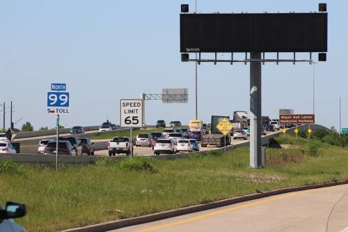 cars drive on a toll road