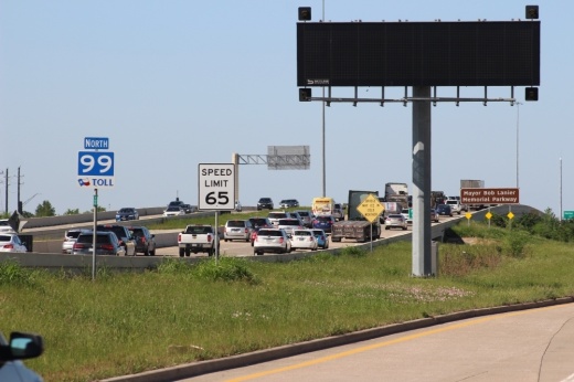 cars drive on a toll road