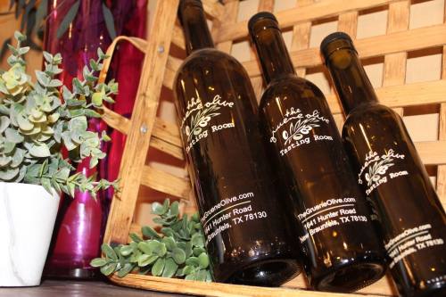 The Gruene Olive Tasting Room contains flavor-infused olive oils, vinegar, dressings and more. (Andrew Creelman/Community Impact)