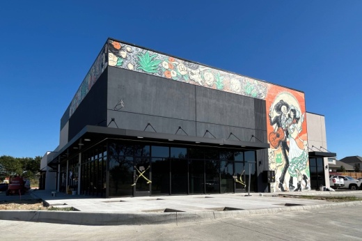 Exterior of the corner space in a strip center featuring a Mexican cultural mosaic.
