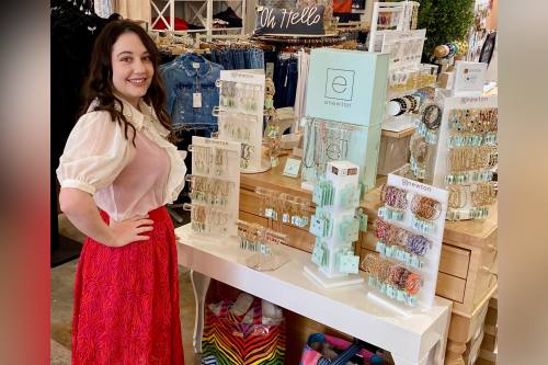 Owner Lucy Evans welcoming shoppers inside Adelyne’s Boutique in Tomball, a local favorite for personalized holiday gifts and fashionable clothing.