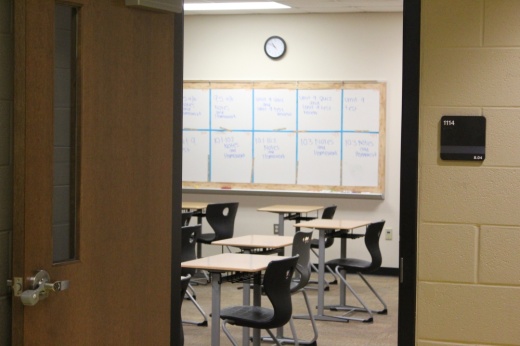 The interior of a classroom with empty desks