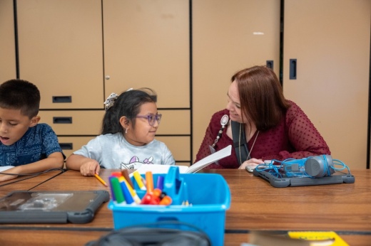 Student and teacher at Kaiser Elementary working on a paper