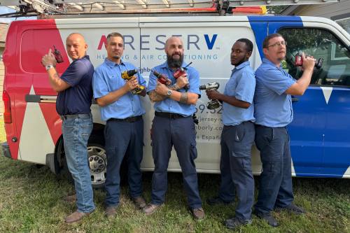 Professional HVAC technician from Aire Serv cleaning air ducts and replacing air filters to improve indoor air quality and system performance.
