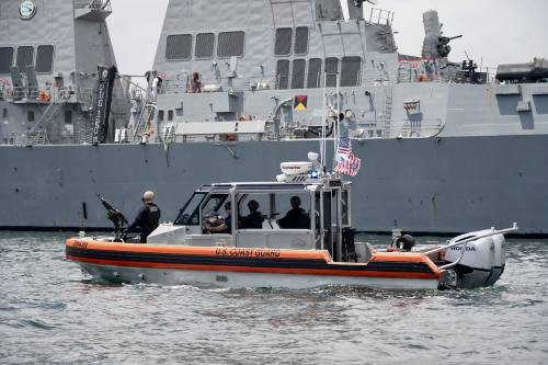 A naval ship in the background