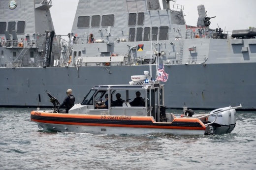 A naval ship in the background
