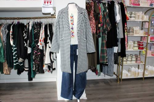 Clothes on a mannequin in a clothing store.