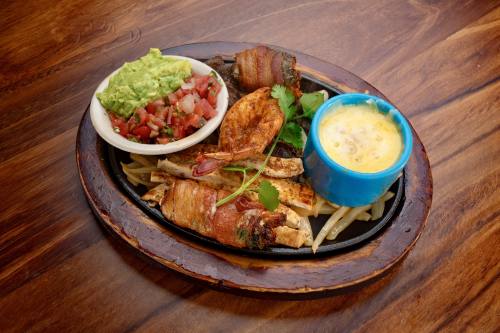 The Don Juan Special made with beef and chicken fajitas, chicken diablo, shrimp brocheta, grilled shrimp and queso and served with guacamole, pico de gallo, charro beans rice and tortillas. (Courtesy Mi Rancho Mexican Grill & Bar )