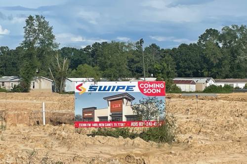 Sign for Swipe gas station with rendering of finished building