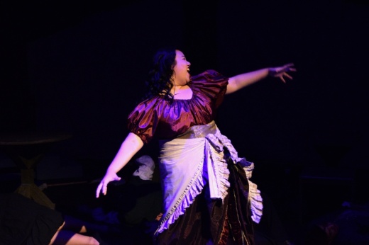 Spartan Theatre Co. student singing on stage in costume