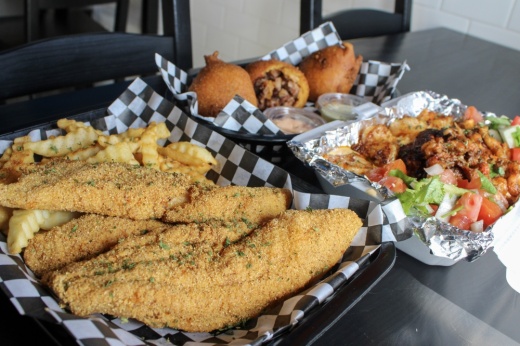 Customers can order a variety of items from fried catfish platters and brisket hushpuppies to seafood platters and cheesesteaks. (Dacia Garcia/Community Impact)