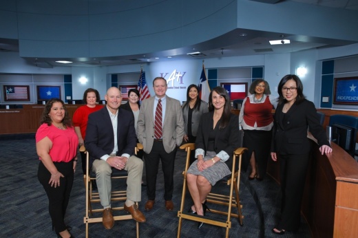 men and women in business casual attire in a group photo
