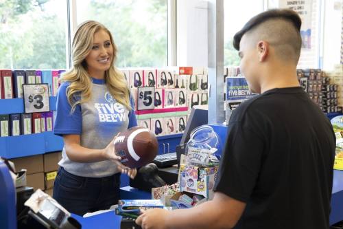 Five Below employee checking out customer who is buying a football