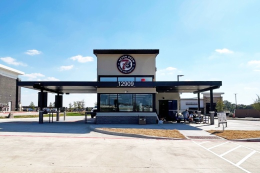 Exterior of a freestanding building featuring 7 Brew signage.