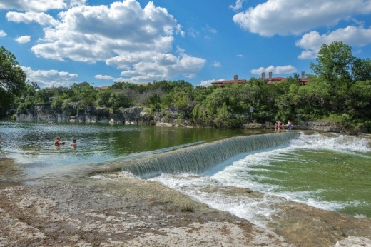 an outdoor natural area with water and trees