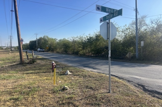 A rural road in Cibolo, Texas is shown on a sunny afternoon.