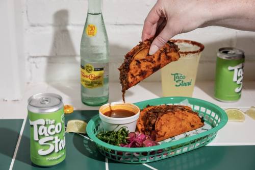 The Taco Stand sells Quesabirria tacos, which are three beef and cheese tacos on corn tortillas served with cilantro, pickled onions and a side of consommé for dipping. (Courtesy The Taco Stand)