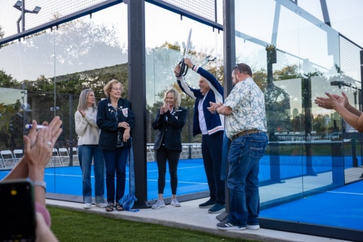 Australian tennis legend John Newcombe cuts the ribbon to his country club's newest padel ball courts.