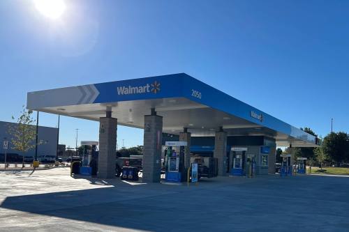 Walmart gas station with vehicles at some of the pumps.