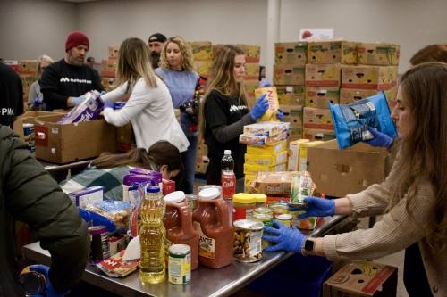 People sorting boxes of food at the Tarrant Area Food Bank.
