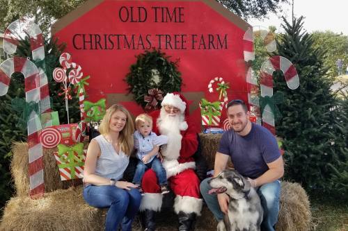 Lindsay Carthen, her husband, Nicholas, and their son, Noah Martin Carthen posing with Santa Claus at Christmas.