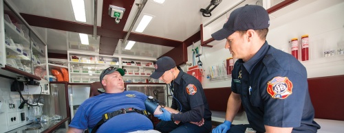 Paramedics Caleb Longino (center) and Taylor Proefrock (right) practice medical scenarios April 29 in one of the city's transitional response vehicles with Travis Vinton (left) at Fire Station No. 5 in Georgetown. 