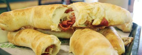 DoubleDaveu2019s Pizzaworksu2019 signature Peproni Rolls are made to order and available at the buffet.