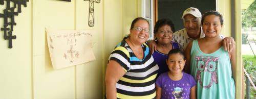 From left: Barbara, Delia, Claire, Marcos and Ellie Hurtado wait outside Delia and Marcos' home on Conway Street, which was flooded during the Memorial Day weekend rains.