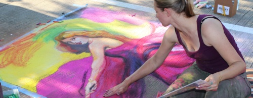 Charlotte Scovill puts the finishing touches on her painting last August at Chalk It Up in Haggard Park in downtown Plano.