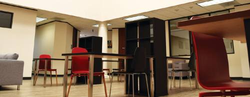 The co-working space at The Hive offers several work areas and couches just off the kitchen.