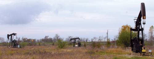 Local pump jacks draw oil and gas from a series of wells south of I-10 in Brookshire. The oil and gas extraction industry has been hit hard by layoffs in recent months.