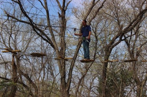 Ben Harris, City of Plano council member, tries the Go Ape Treetop Adventure Course in Plano on March 18. He swung from the ropes, used the zipline and completed the course. 