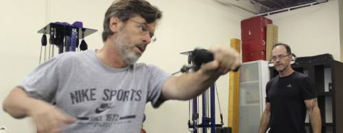 Scott Hentschel (left) works out as trainer Tony Kelly oversees a one-on-one session.