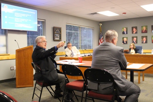 Lester Wolff, assistant superintendent for human resources (left) and David Edgar, assistant superintendent for business services, discuss the 2016-17 budget with the Eanes ISD board of trustees.n