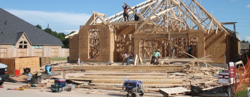 A construction crew works on a house in the Cane Island development in Katy. Hundreds of homes are being built to keep up with demand in Katy.
