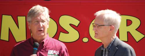Bobby Jenkins (left), CEO of ABC Home and Commercial Services, addresses how to lessen the Zika virus contraction risk at the Loop 360 boat ramp May 11. Marshall Cothran (right), CEO of the Blood and Tissue Center of Central Texas, discusses the danger of the virus to the areau2019s blood supply.