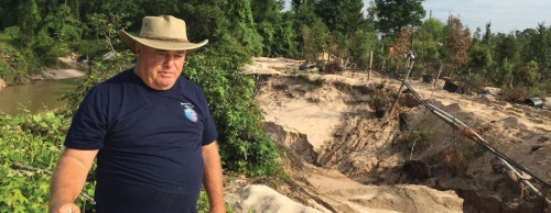 Richard Gieseke explains the damage to Spring Gardens Nursery after Willow Creek flooded onto the property. The fast-moving water carved a large trench and toppled 15-year-old potted trees, causing at least $2 million in damages. The nursery was closed to customers for one week. 
