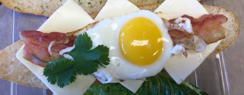 Breakfast sandwiches include combinations of egg, cheese and bacon, ham or sausage on a roll. Lunch sandwich options include meatball, chicken, pork, beef, cold cut and tofu banh mi.