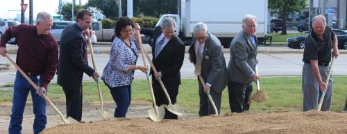 State and local representatives break ground at William Cannon Drive for an I-35 project.