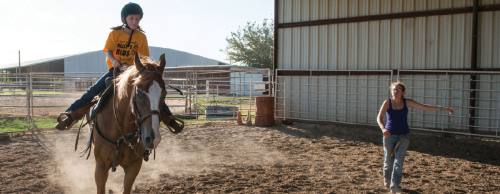 Riding instructor Aaren Horak teaches rider Sydney Wiebe in one of the outdoor arenas.