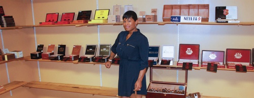 Jessalyn Saunders helps customers at Cigar Envi who are interested in pairing cigars with a variety of alcoholic beverages. The business has dozens of varieties of cigars for sale. 