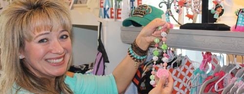 Owner Dana Smyth displays some of the jewelry made by her daughters, Faith and Parker.