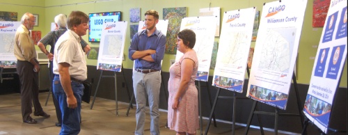 Doise Meirs (right), public information officer for the Capital Area Metropolitan Planning Organization, discusses amendments to CAMPO plans with Lake Travis residents.