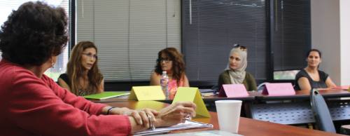 Literacy Council students engage in a small group English conversation circle to practice their language skills.