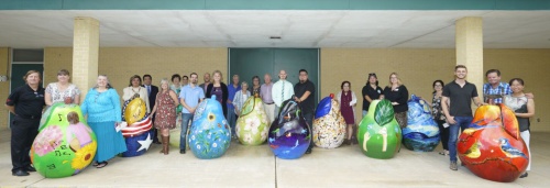 The Pearland Convention & Visitor's Bureau spearheaded the Pear-Scape Art Sculpture Trail project, a public art installation of 20 pears in parks around the city. Above, 11 artists stand with private sponsors with 10 of the 20 commissioned pears.
