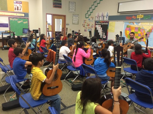 Austin Classical Guitar instructor Toby Rodriguez teaches students a guitar lesson at Widen Elementary School in Austin.