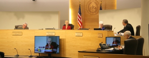 Members of the Travis County Commissioners Court meet Jan. 3 for a meeting. From left: Commissioner Gerald Daugherty, Judge Sarah Eckhardt, Commissioner Brigid Shea and Commissioner Jeff Travillion sit at the dais.