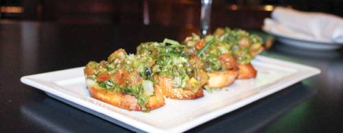 Featuring a housemade topping of olive oil, tomato and basil, Bruschetta Rustica is a popular appetizer from Lomonteu2019s menu.